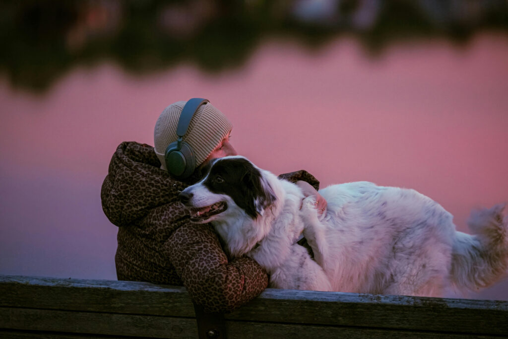 sitting on a bench with a pet dog