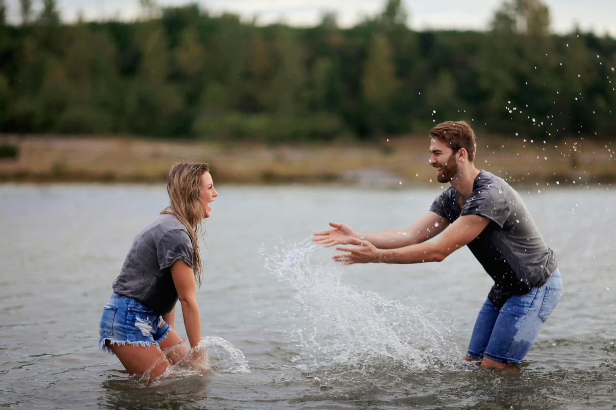 couple playing in a lake couple playing in a lake