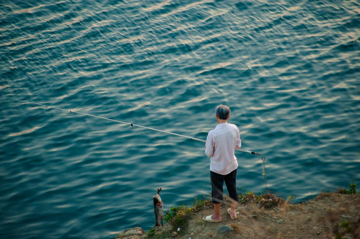 man fishing on a lake